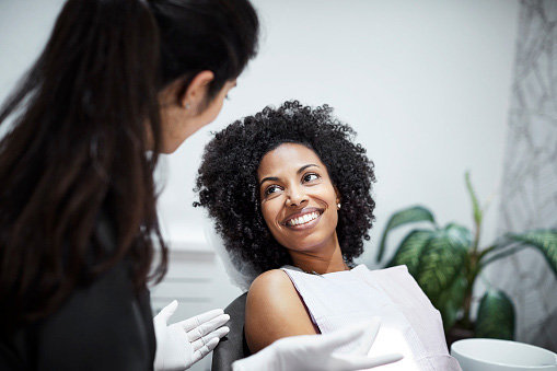  Beautiful Black woman smiling at Implant and Periodontal Wellness Center of Arizona in Phoenix, AZ